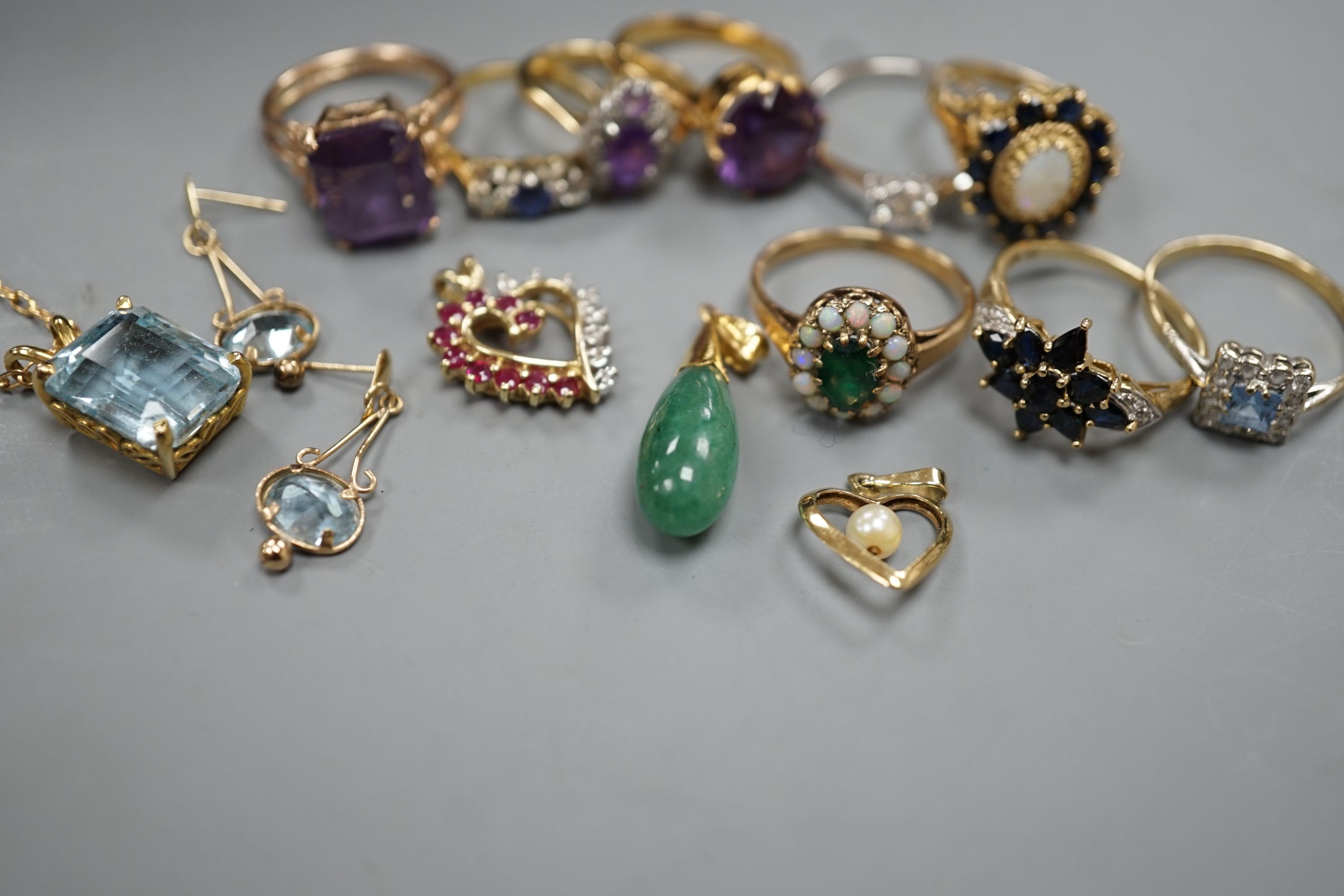 Two 18ct and gem set rings, including amethyst and diamond, size K and sapphire and diamond three stone, size J/K, gross 5.5 grams, four 9ct and gem set rings and two 9ct and gem set pendants, gross 19.9 grams, two yello